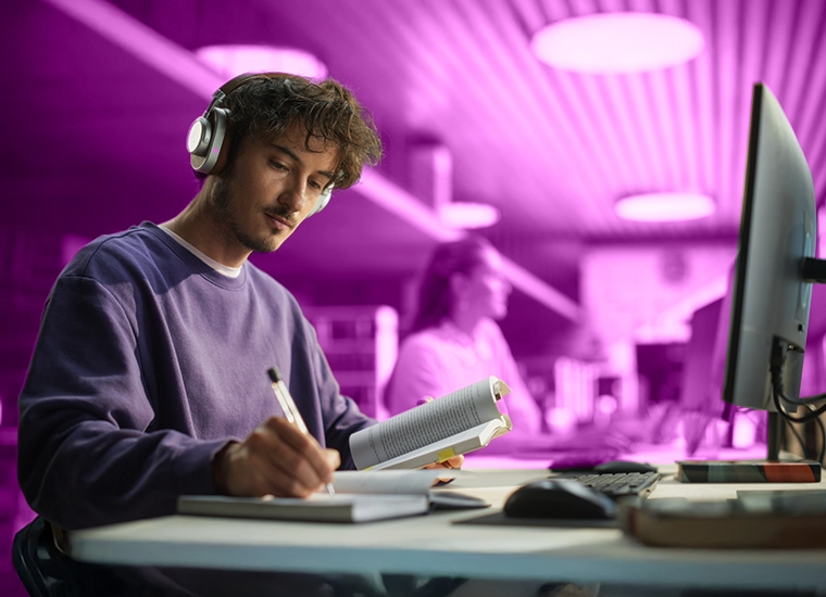 Highlight tile - students studying in a library. Link to Libraries web page