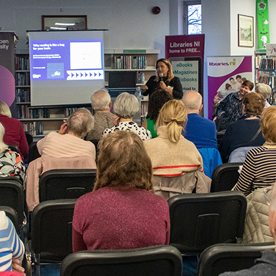Libraries NI Making A Difference - photo of speaker and attendees at a Changing Attitudes to Ageing event in Derry Central Library