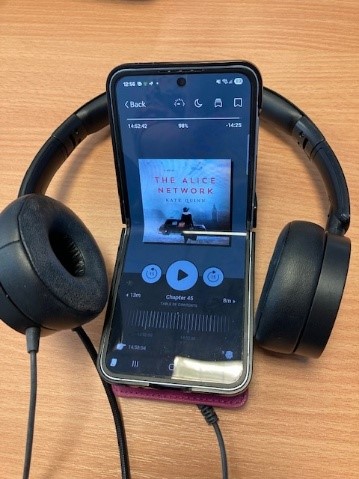 e-Audiobook on a mobile phone and headphones